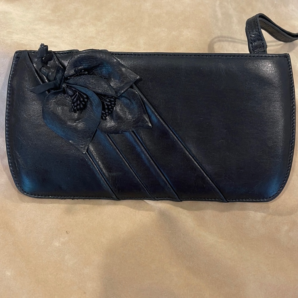 Black leather Violette Nozieres clutch with leather leaf detail.